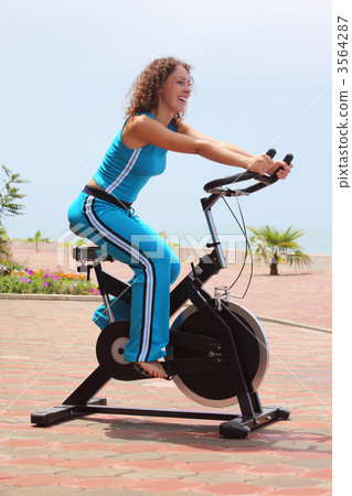 smiling girl on bicycle training apparatus outdoor smiling girl on bicycle training apparatus outdoor 3564287