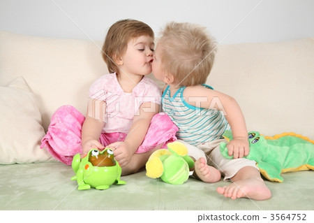 two children kissing on sofa two children kissing on sofa 3564752
