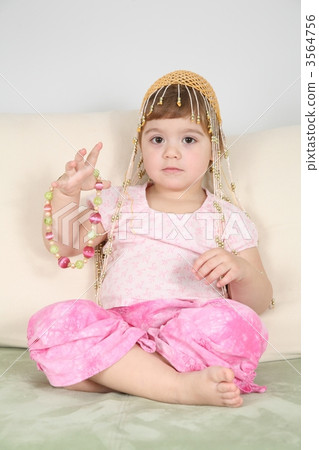 girl on  sofa in  eastern hat with beads 3564756