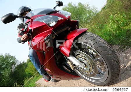 motorcyclist standing on country road, bottom view 3564757