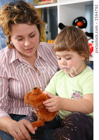 mother with child in playroom with soft toy mother with child in playroom with soft toy 3564792