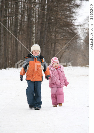 brother and sister walk in park in winter 3565269
