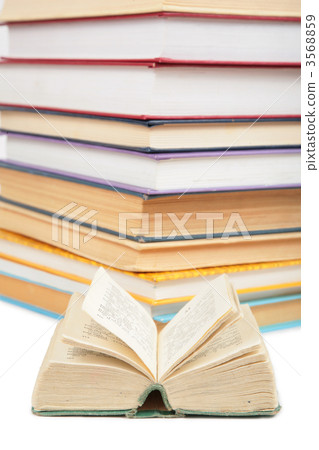 Big stack of books and opened small book 2 3568859
