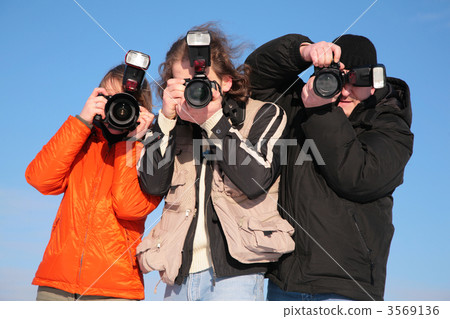 three photographers against blue sky 3569136