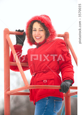 pretty woman on metallic ladder in winter pretty woman on metallic ladder in winter 3570035