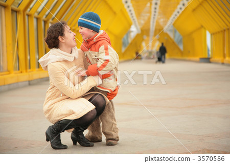 mother and son look each other on footbridge mother and son look each other on footbridge 3570586