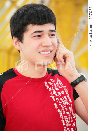young man talks by cell phone on yellow footbridge young man talks by cell phone on yellow footbridge 3570854