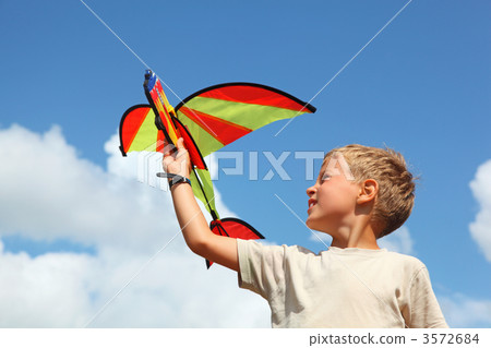 boy plays kite against sky 3572684