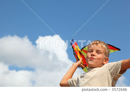 boy plays kite against sky 3572686