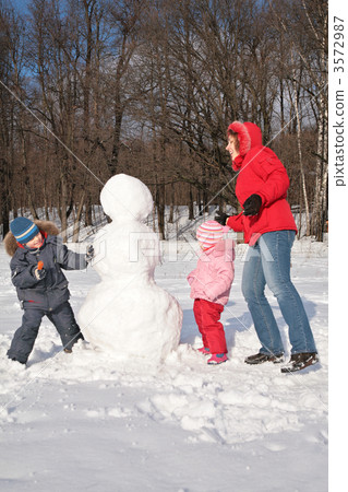 mother and children make snowman 3572987