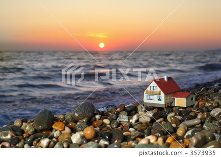 model of house with garage on stony beach in evening model of house with garage on stony beach in evening 3573935