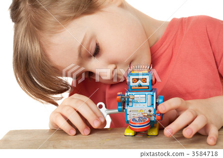 little girl in red T-shirt plays with clockwork robot isolated o 3584718