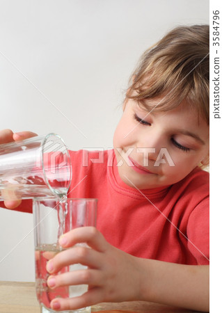 little girl in red shirt pour out water from one glass to other, little girl in red shirt pour out water from one glass to other, 3584796