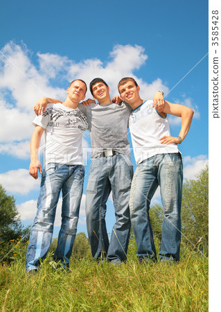 Three friends stand on grass Three friends stand on grass 3585428