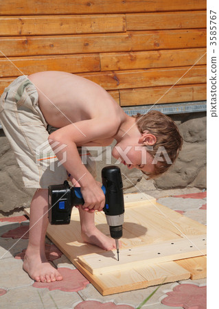 Boy drills an electrodrill 3585767