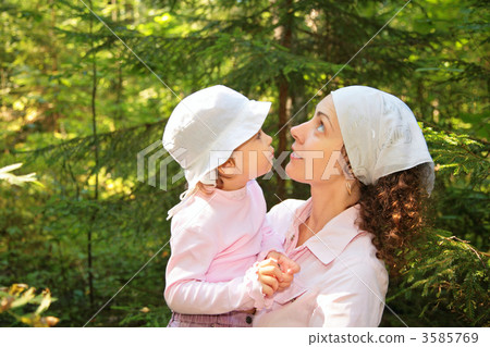 mother holds daughter on hands 3585769