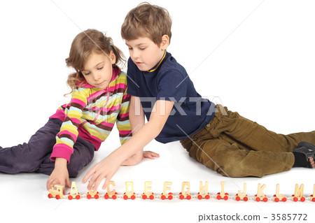 little boy and girl playing with wooden railway sitting on floor 3585772