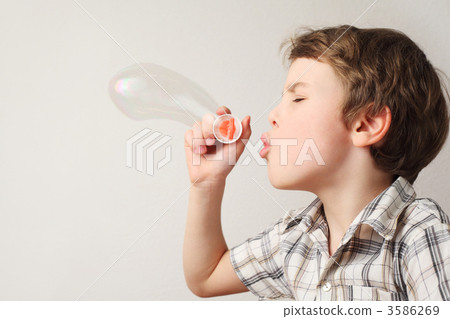 little caucasian boy blowing soap bubbles on white background, s little caucasian boy blowing soap bubbles on white background, s 3586269