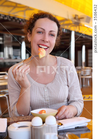 beauty curl woman in white shirt eating fruits in cruise liner r beauty curl woman in white shirt eating fruits in cruise liner r 3586432