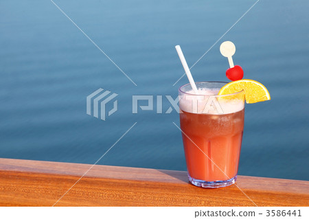 cocktail with fruits in glass on ship deck rail, sea on backgrou cocktail with fruits in glass on ship deck rail, sea on backgrou 3586441