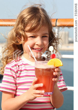 little girl in shirt with pink stripes holding cocktail with fru little girl in shirt with pink stripes holding cocktail with fru 3586448