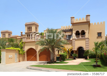 big arabian style house with two garages and archs, yard with pa 3586717