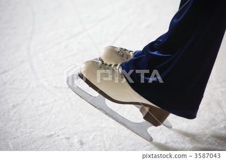 Human feet in fads standing on ice on the brink of an edge on sk 3587043
