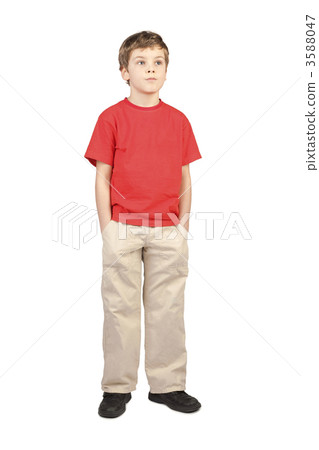 little boy in red shirt hands in pockets standing on white backg 3588047