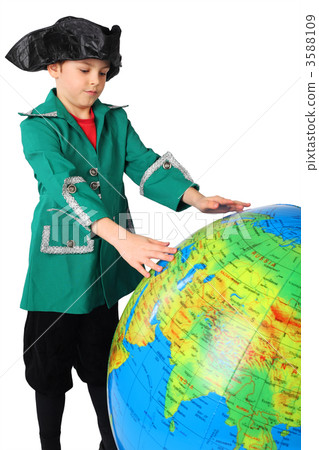 little boy in historical dress looking at big inflatable globe i 3588109
