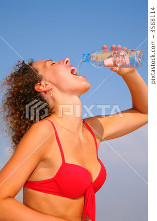 Girl in red bikini drinking water 3588114