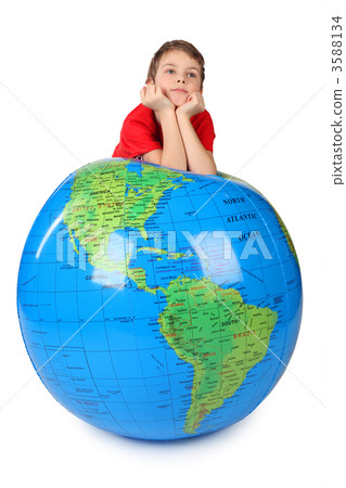 boy in red shirt leans on inflatable globe chin on hands  isolat 3588134