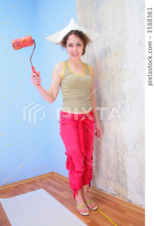 young woman with roller in paper hat 3588361