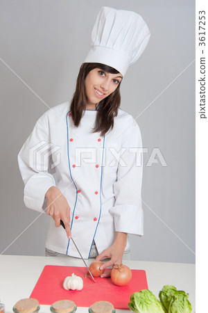 Young chef chopping an onion 3617253