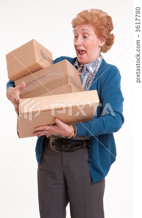 Alarmed senior woman with packages Alarmed senior woman with packages 3617780