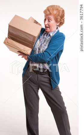 Busy senior woman with heavy parcels 3617794