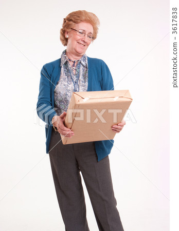 Happy senior woman holding a package Happy senior woman holding a package 3617838