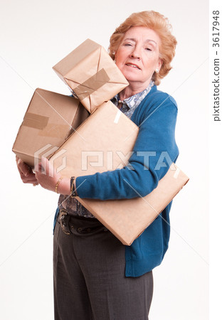 Senior woman carrying lots of heavy parcels 3617948