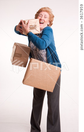 Senior woman with falling parcels 3617959