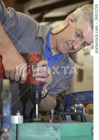 worker and hand drill worker and hand drill 3663159