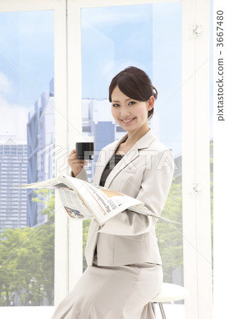 Business woman looking at the newspaper while taking a break Business woman looking at the newspaper while taking a break 3667480