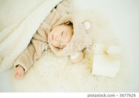 A gift for a baby and a bedside sleeping in a costume 3677626