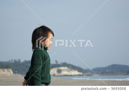 A boy staring at the sea with a smile A boy staring at the sea with a smile 3693008