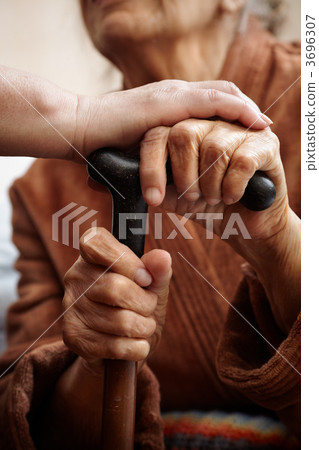 adult helping senior in hospital 3696307