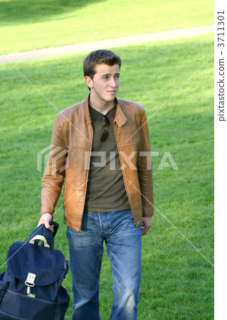 casual student holding his bag casual student holding his bag 3711301