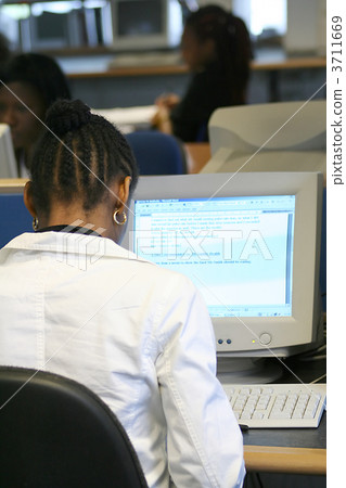 girl on a computer - library girl on a computer - library 3711669