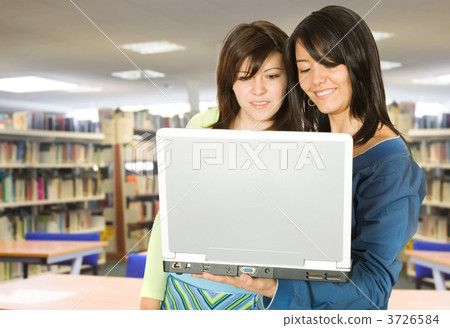 girls in the library with a laptop 3726584