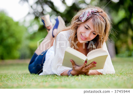 Woman outdoors reading Woman outdoors reading 3745944
