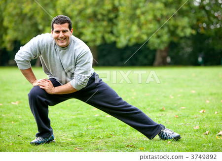 Man stretching outdoors Man stretching outdoors 3749892