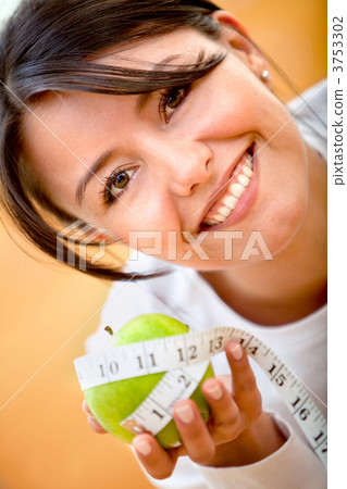 Measuring tape around an apple 3753302