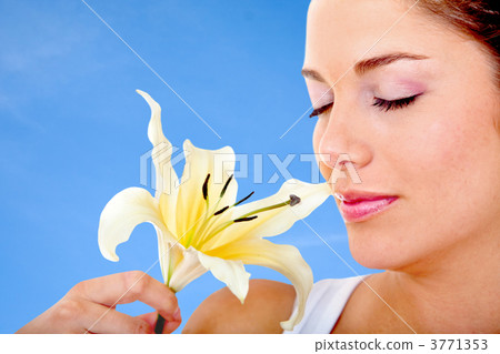 Woman smelling a flower Woman smelling a flower 3771353